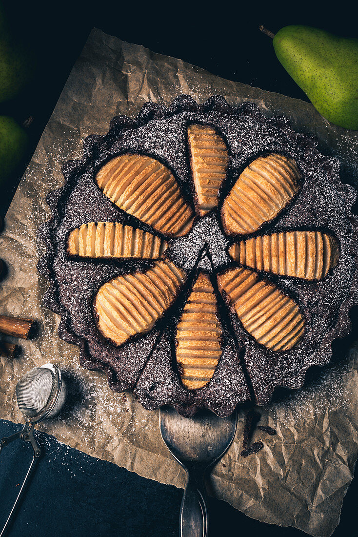 A pear and chocolate tart on baking paper