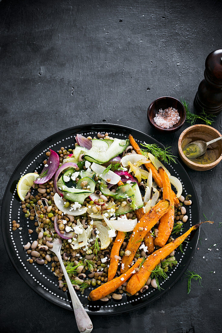 Lentils and beans vegan salad with roasted and fresh vegetables and crumbled vegan feta