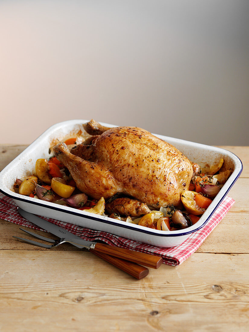 Roast chicken with vegetables in a roasting tray