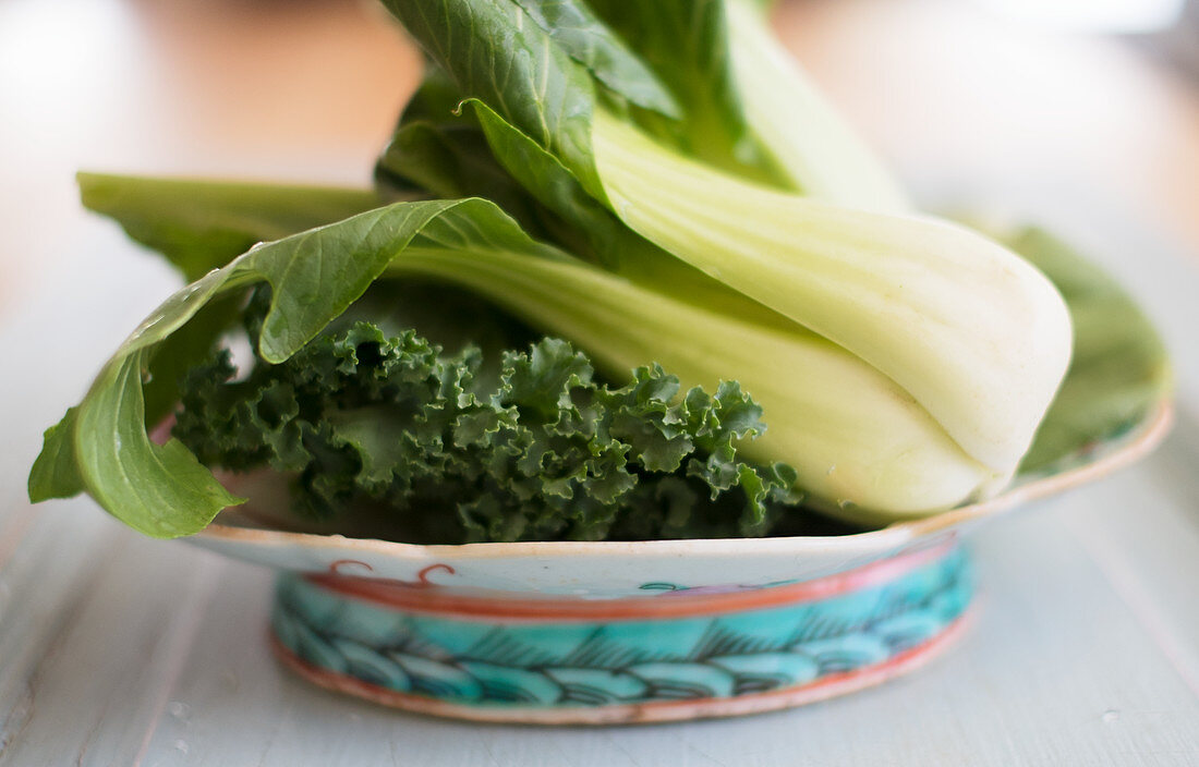 Bok choy and kale in a ceramic bowl