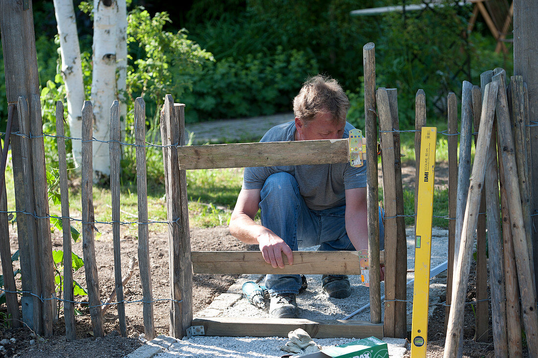 Man building a garden gate
