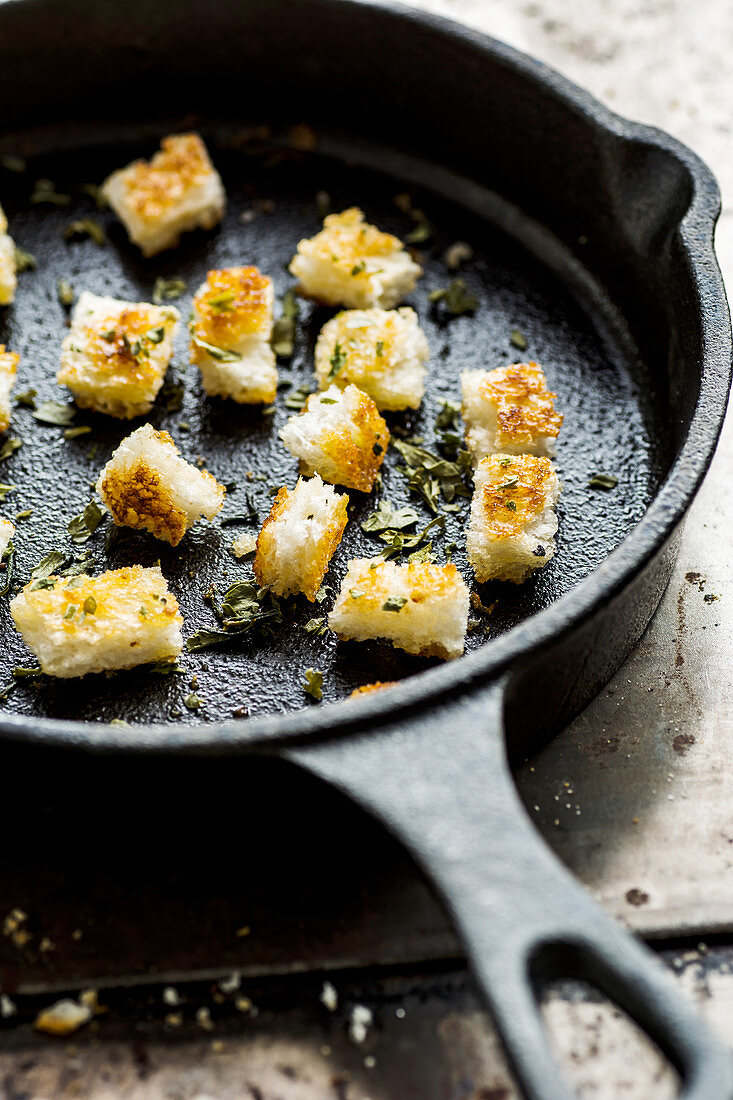 Croutons with herbs on pan