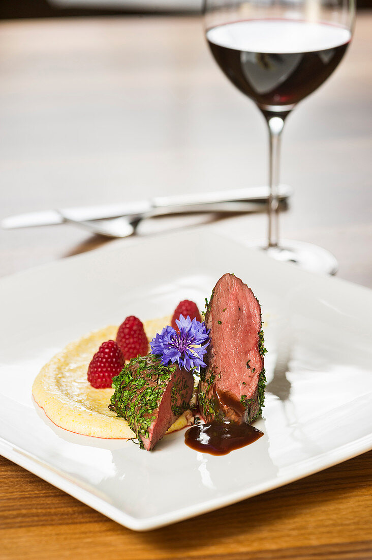 Venison fillet with creamy polenta and raspberries