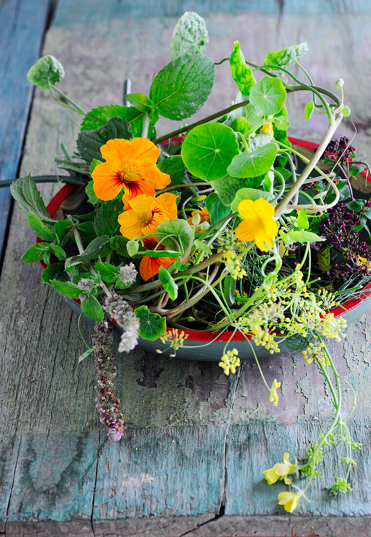Fresh flowering herbs in a bowl