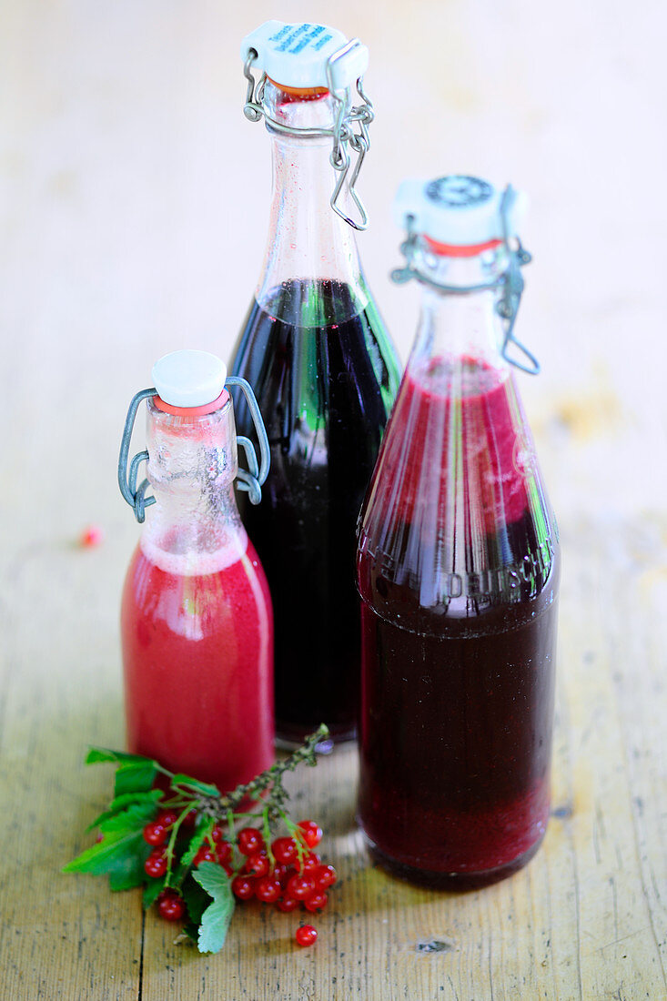 Homemade red currant juice in glass bottles
