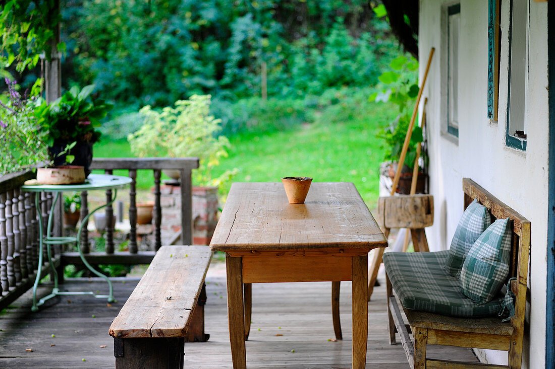 Wooden table and benches on veranda