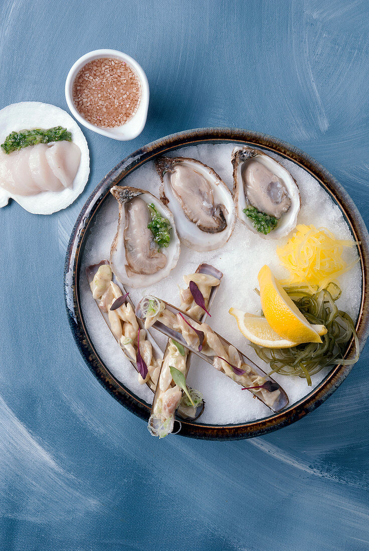 Oysters, razor clams and scallops with a side of mignonette sauce.