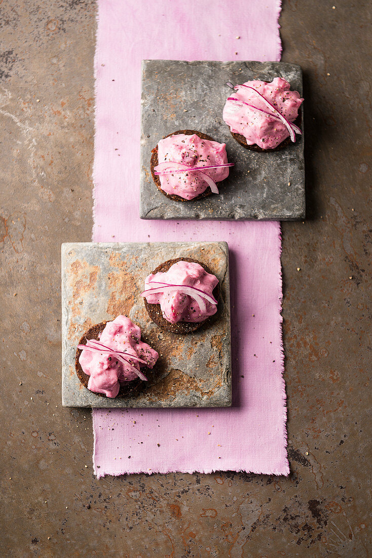 Herring salad with beetroot and red onions on pumpernickel bread