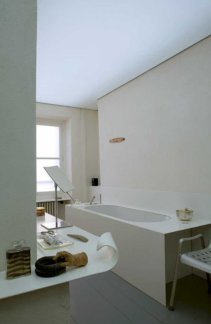 Bathtub and designer shelf in bathroom