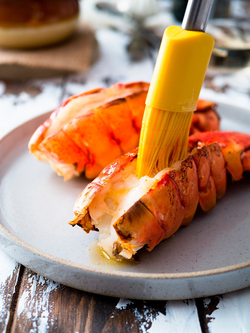 Melting butter on broiled lobster tails