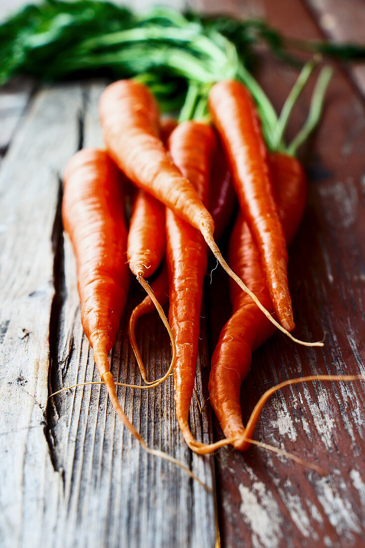 Fresh carrots on a rustic wooden surface