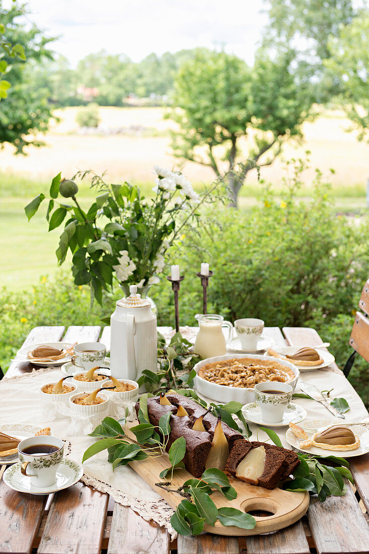 A table laid with various pear cakes and desserts
