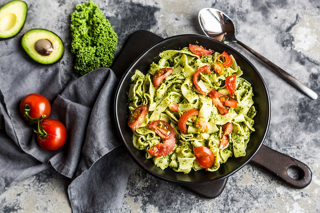 Tagliatelle with green kale pesto and tomatoes