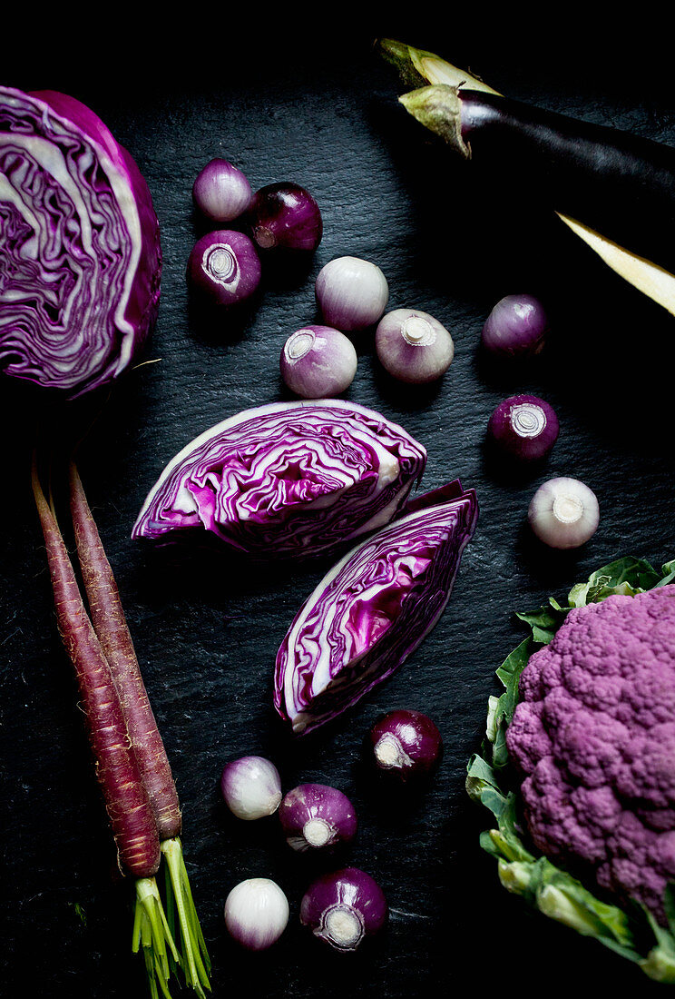 Purple cauliflower, purple cabbage, purple carrots, purple and white pearl onions and eggplant