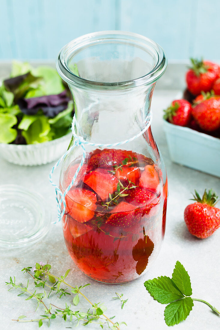 Homemade strawberry vinegar in a carafe