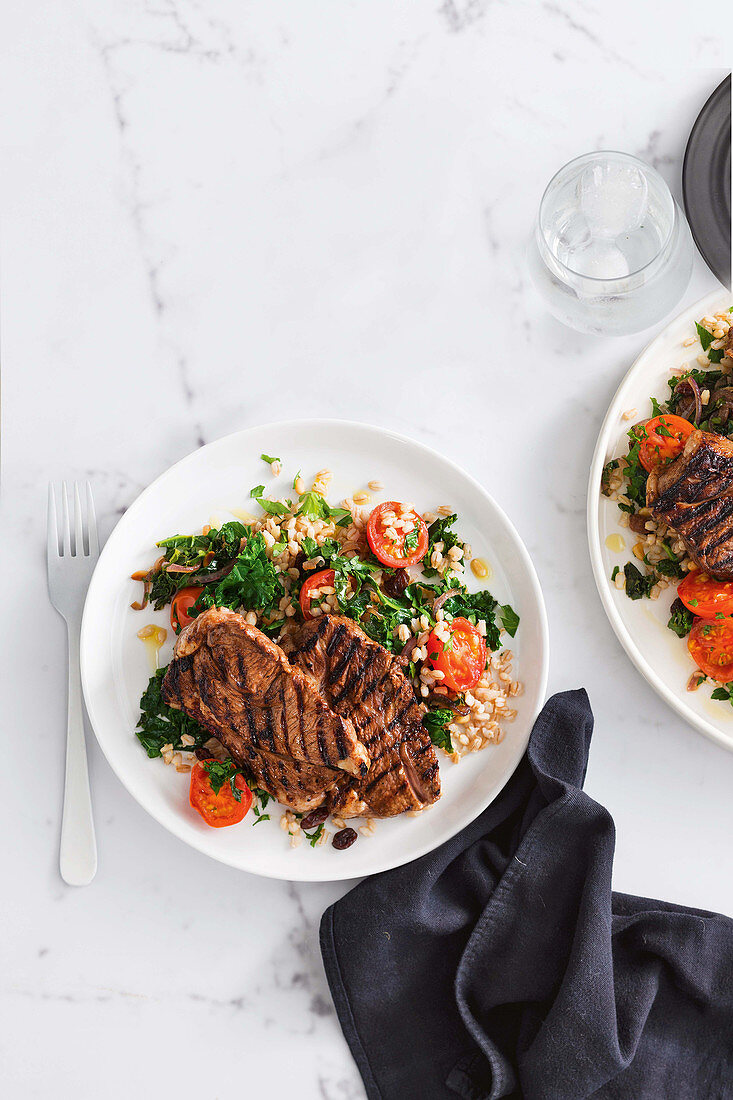 Barbecued lamb with warm barley and kale salad