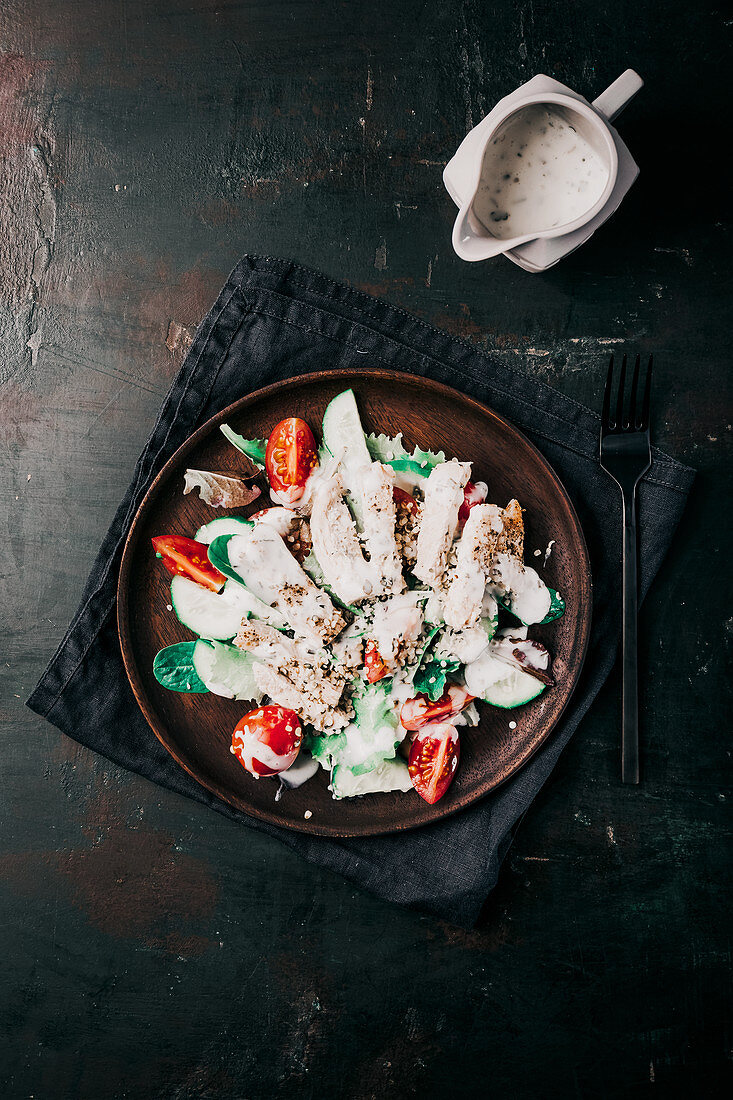 Tomato and cucumber salad with chicken, hemp seeds and yoghurt dressing