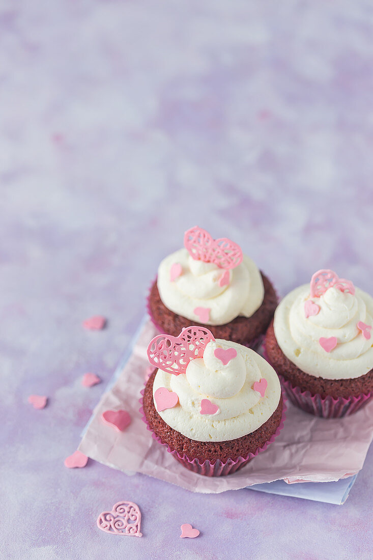 Red velvet cupcakes with cream cheese and pink sugar hearts