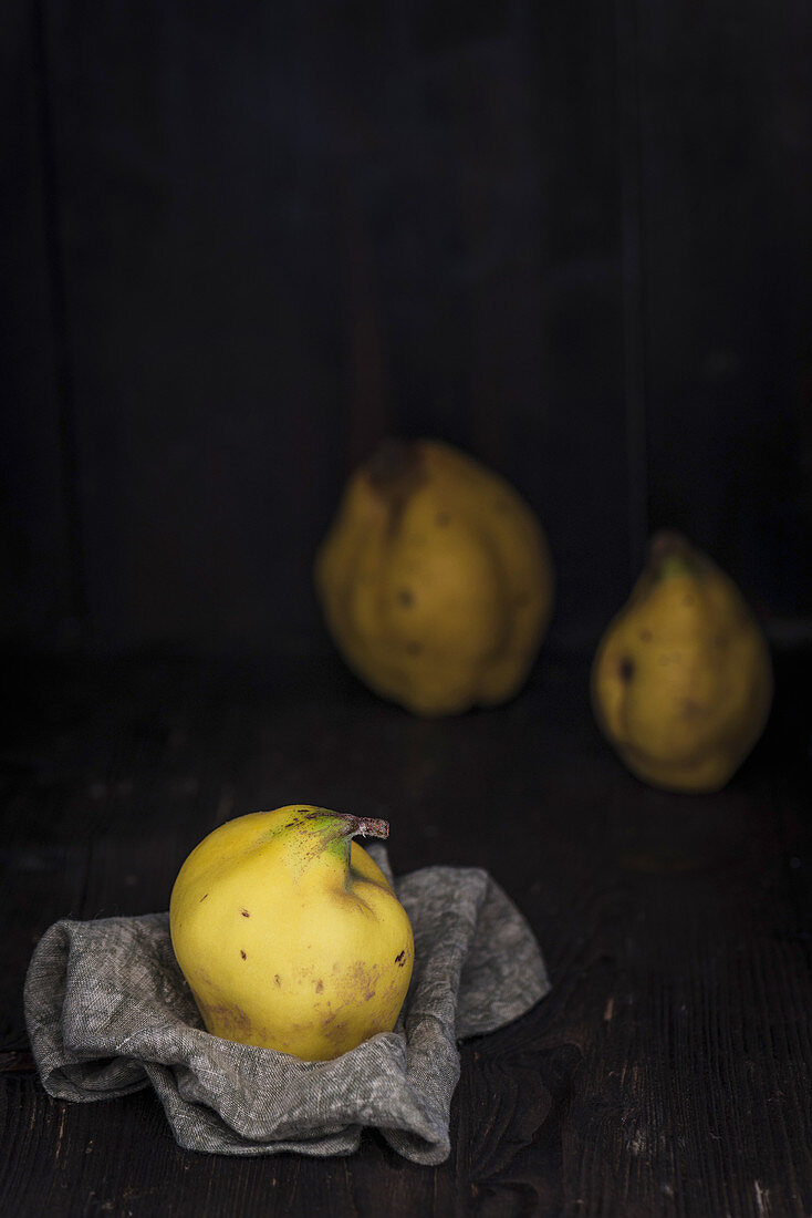 Quinces on a cloth and behind it