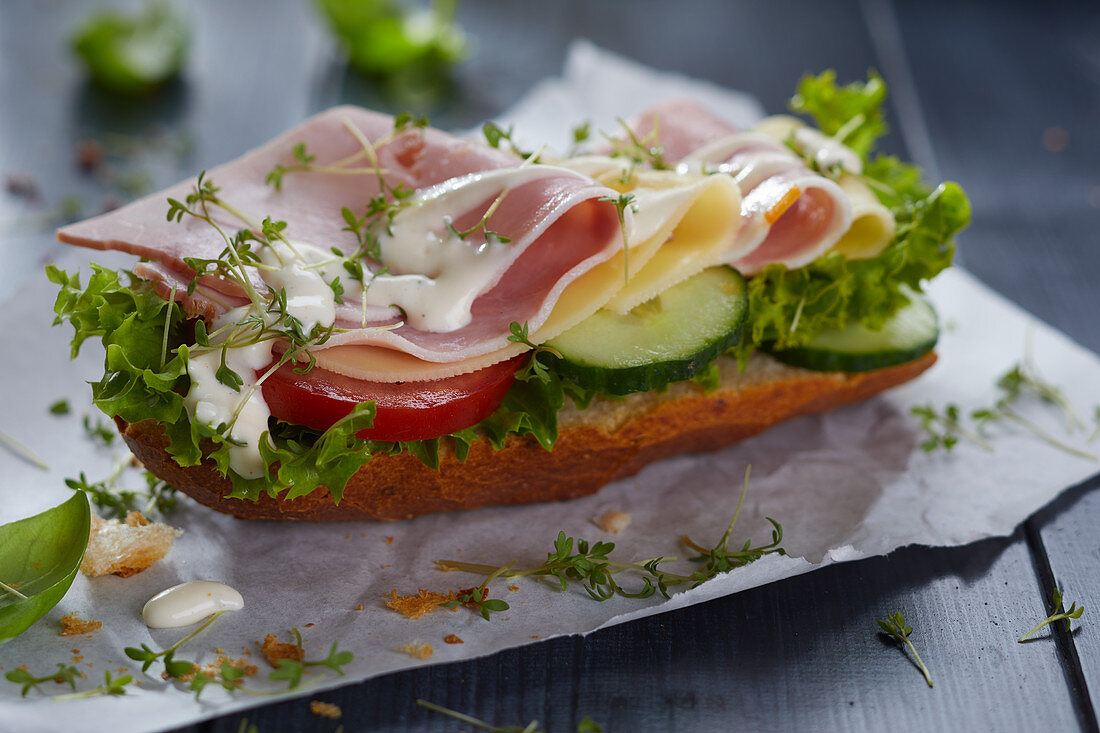 A sandwich with ham, cheese, mayonnaise and cress