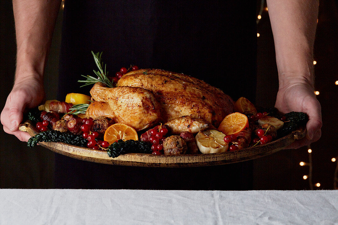 Winter roast chicken with fruit and vegetables being served