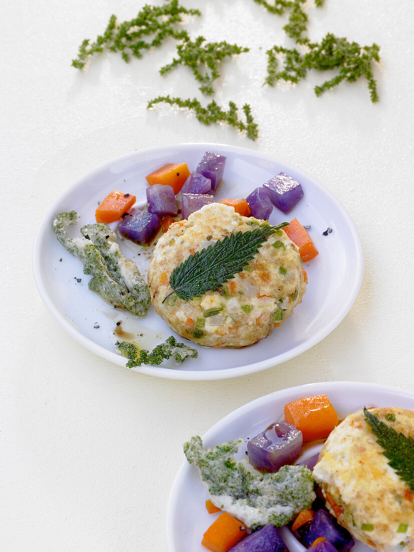 Stinging nettle and tofu fritters with mange tout, carrots and purple potatoes