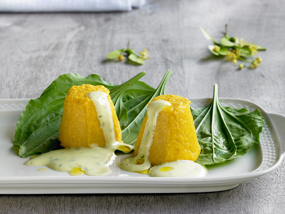 Carrot flans with wild herbs and sour cream sauce