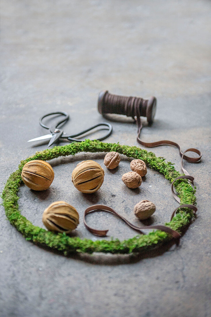 Dried orange pomanders and walnuts in narrow wreath of moss