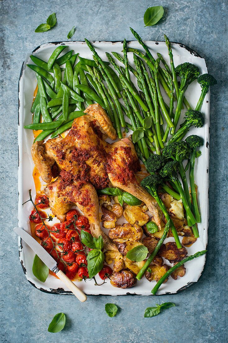 Spatchcock chicken with sun dried tomato paste and spring vegetables