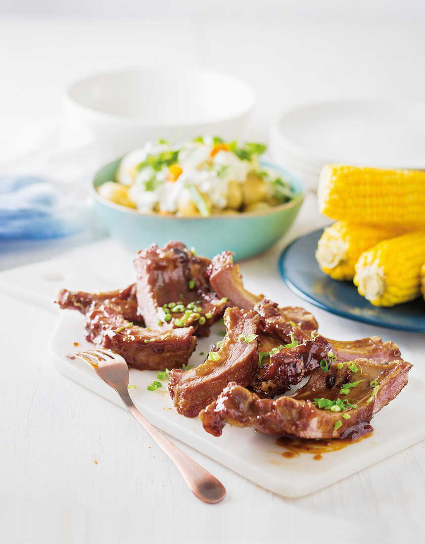 Spare ribs with herby potato salad and corn