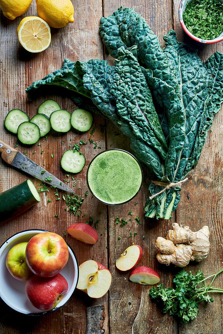 Fresh detox juice with ginger, lemons, apple, cabbage, cucumber and chives