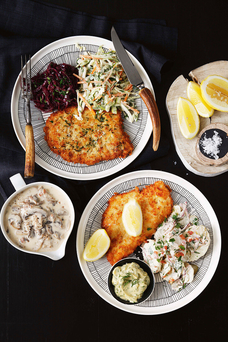 Wiener schnitzel with red cabbage, vegetable and potato salad and hunter's sauce