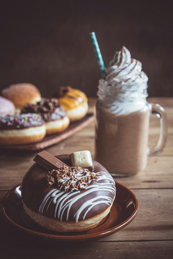 Chocolate donut and jar of coffee, selective focus