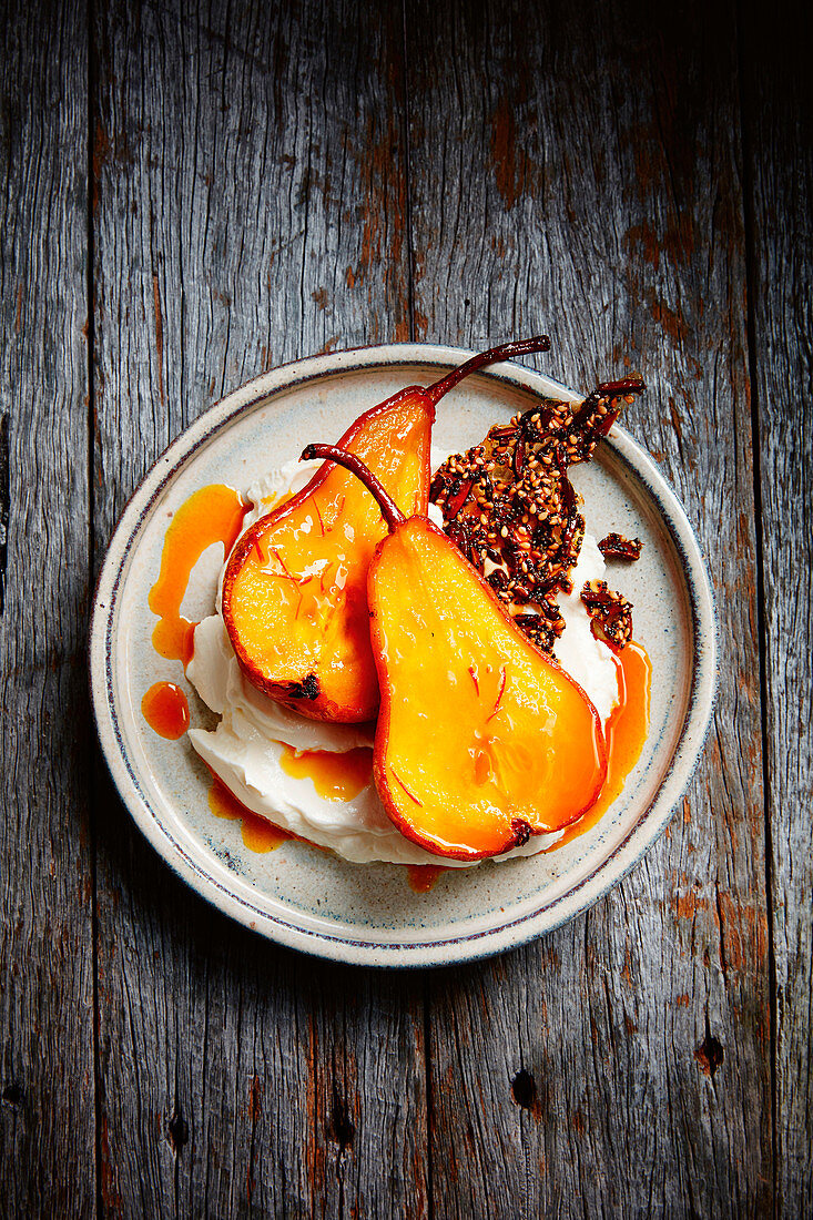 Safron baked pears with seed praline and labne