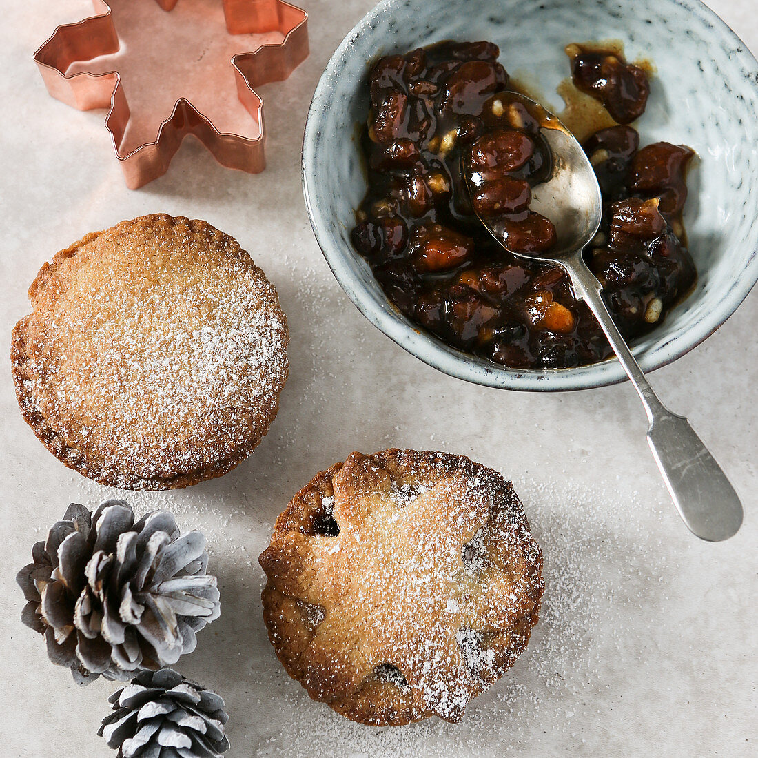 Mince pies, mince pie filling, a cookie cutter, and pine cones