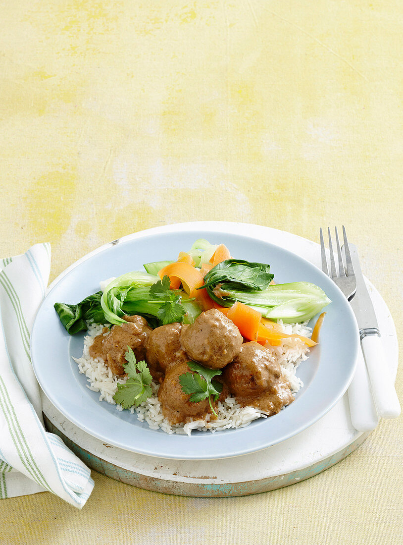 Satay pork meatballs with veg and rice