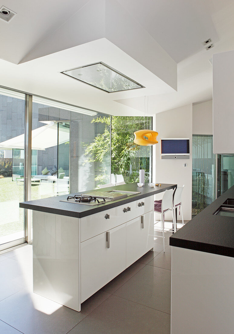 Island counter and glass wall in modern designer kitchen