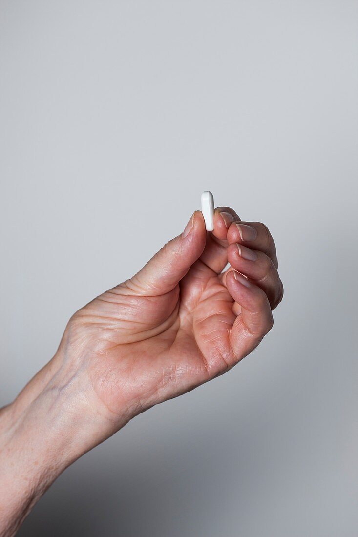 Elderly patient taking a pill