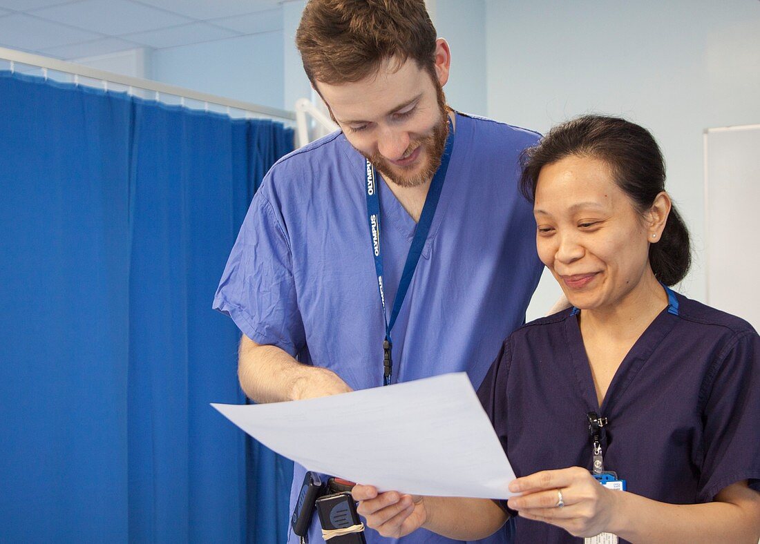 Doctor and nurse discussing patient notes