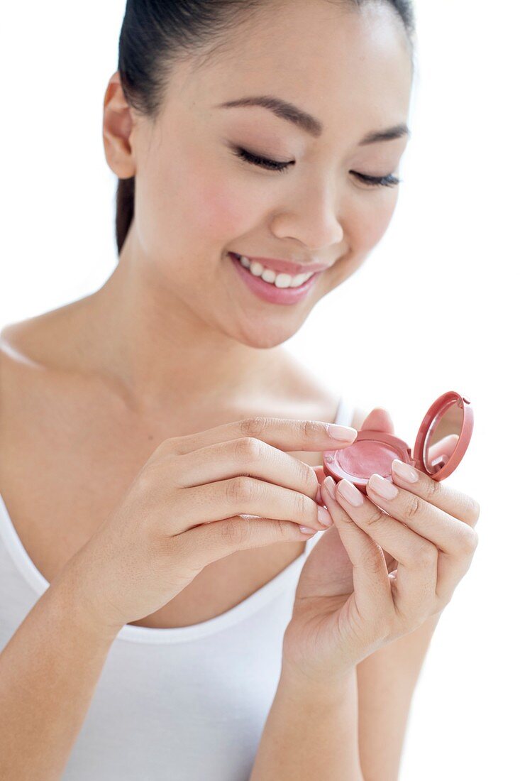 Woman applying make up