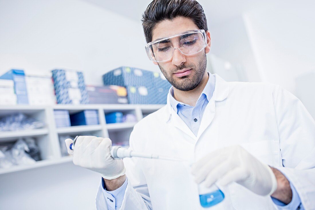 Lab assistant using pipette