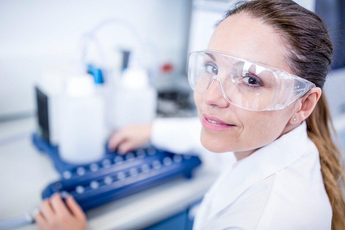 Lab assistant using equipment