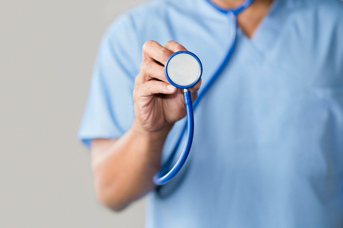 Male doctor in blue uniform with stethoscope