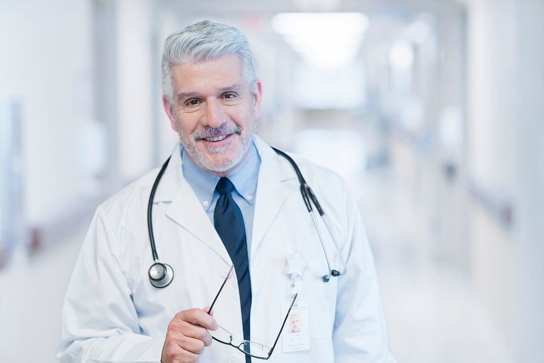 Mature male doctor smiling towards camera