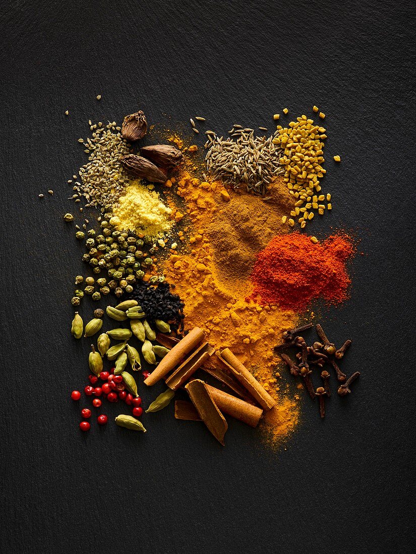 Dried spices on black slate