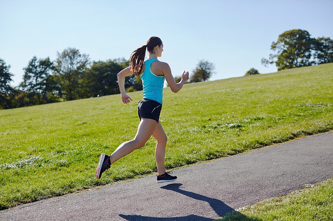 Young woman jogging on a path