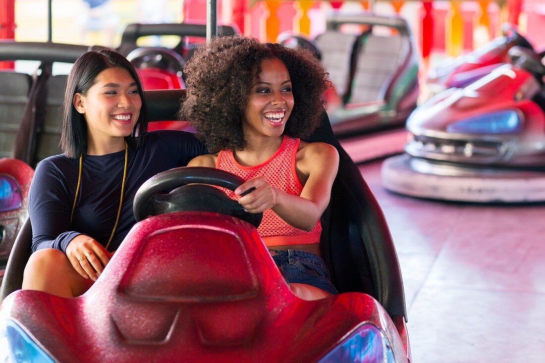 Women on bumper car at fun fair