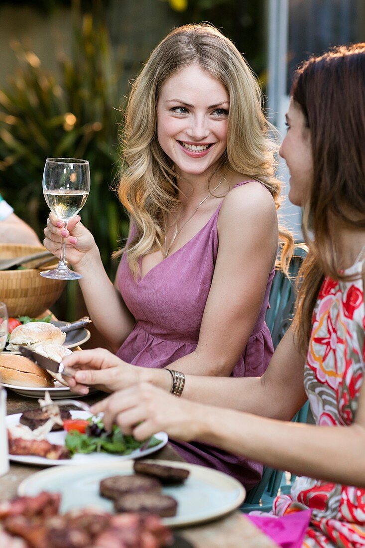 Woman having lunch outdoors with friends