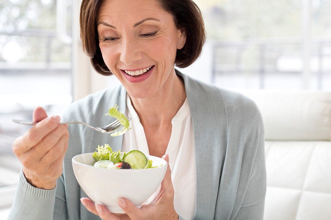 Mature woman eating salad