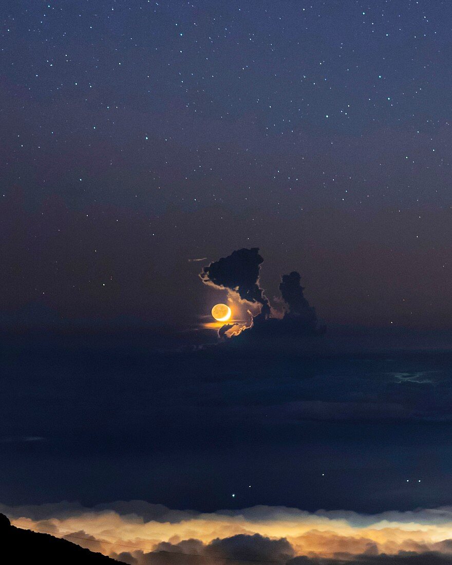 New moon over clouds